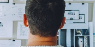 man in front of noticeboard