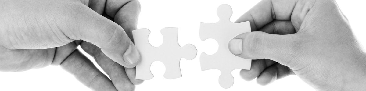 Hands joining puzzle pieces together