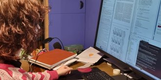 woman looking at research results on a computer screen