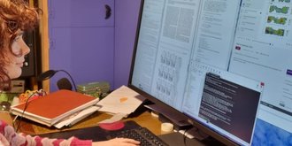 woman looking at research results on a computer screen