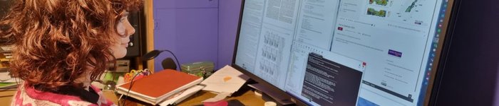 woman looking at research results on a computer screen